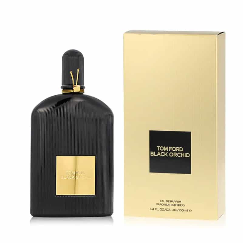 a black bottle with gold label next to a box