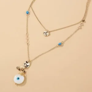 a necklace with a blue eye and a white pendant